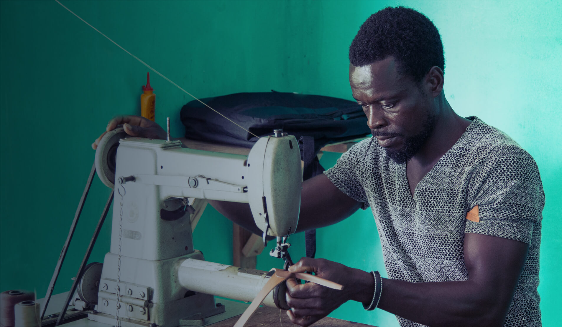 Ghanaian man using sewing machine