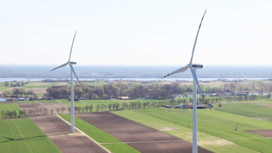 Two wind turbines in a field